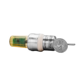 Compact medical injector with a yellow-tinted chamber and metal barrel, shown with a coin for scale